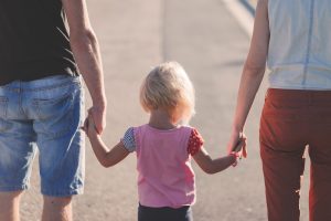 Child holding hands with her parents | Child custody